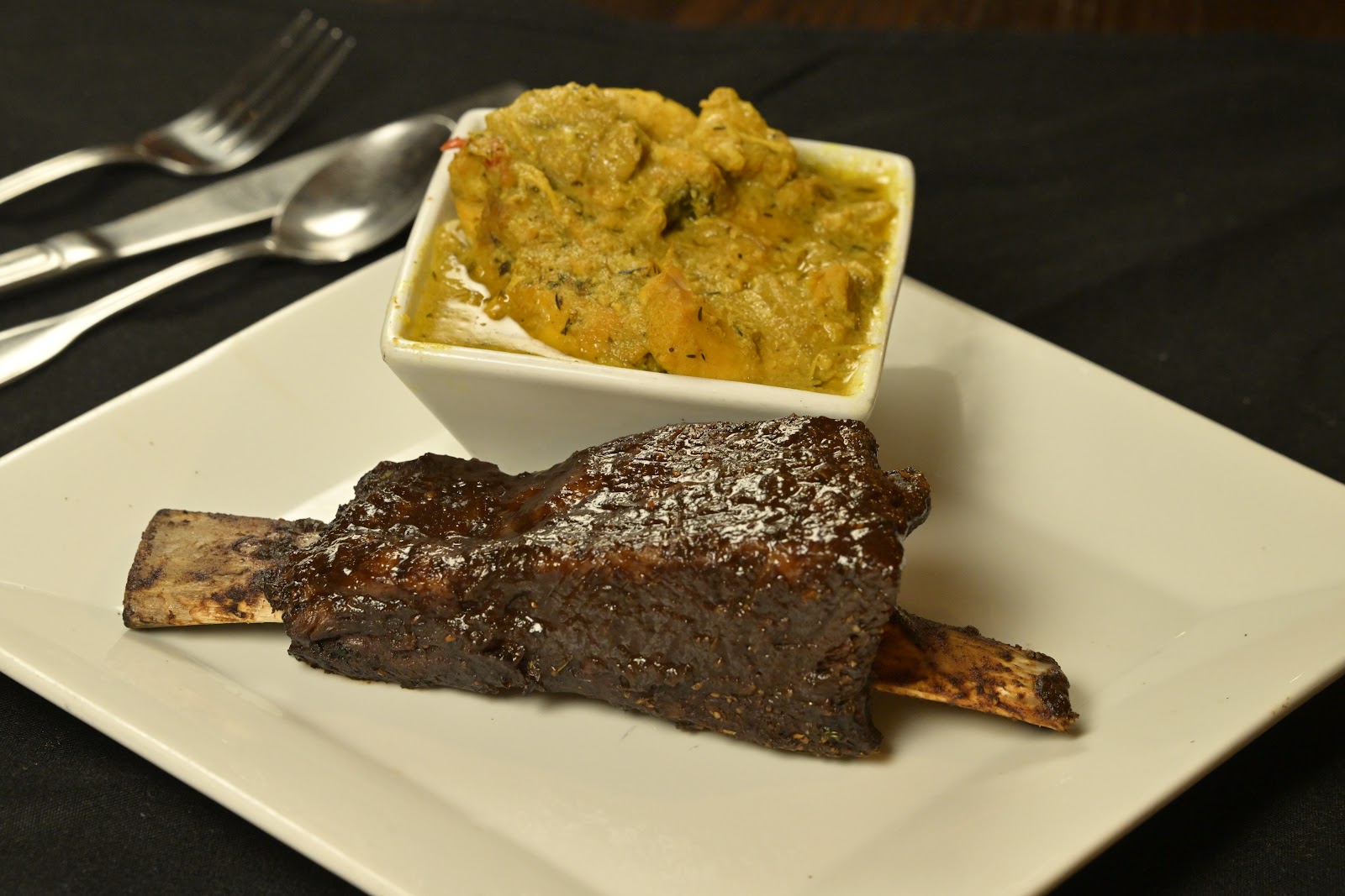Golden curry served alongside a glazed short rib