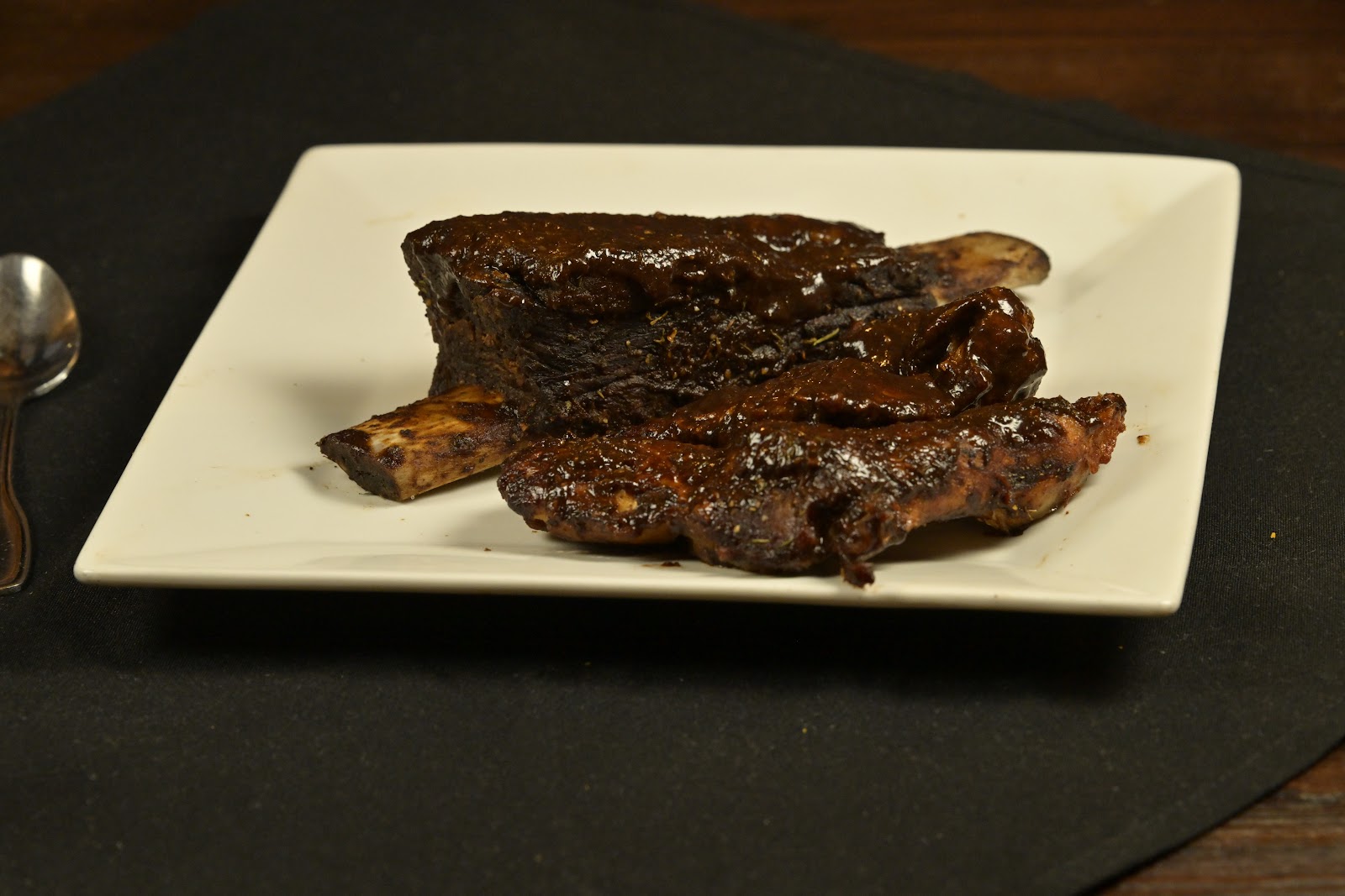 Glazed beef short rib on a white plate